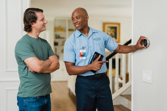 HVAC Aire Serv technician servicing residential air conditioning unit for business owners exploring franchise opportunities