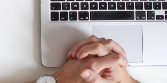 hands resting on laptop keyboard